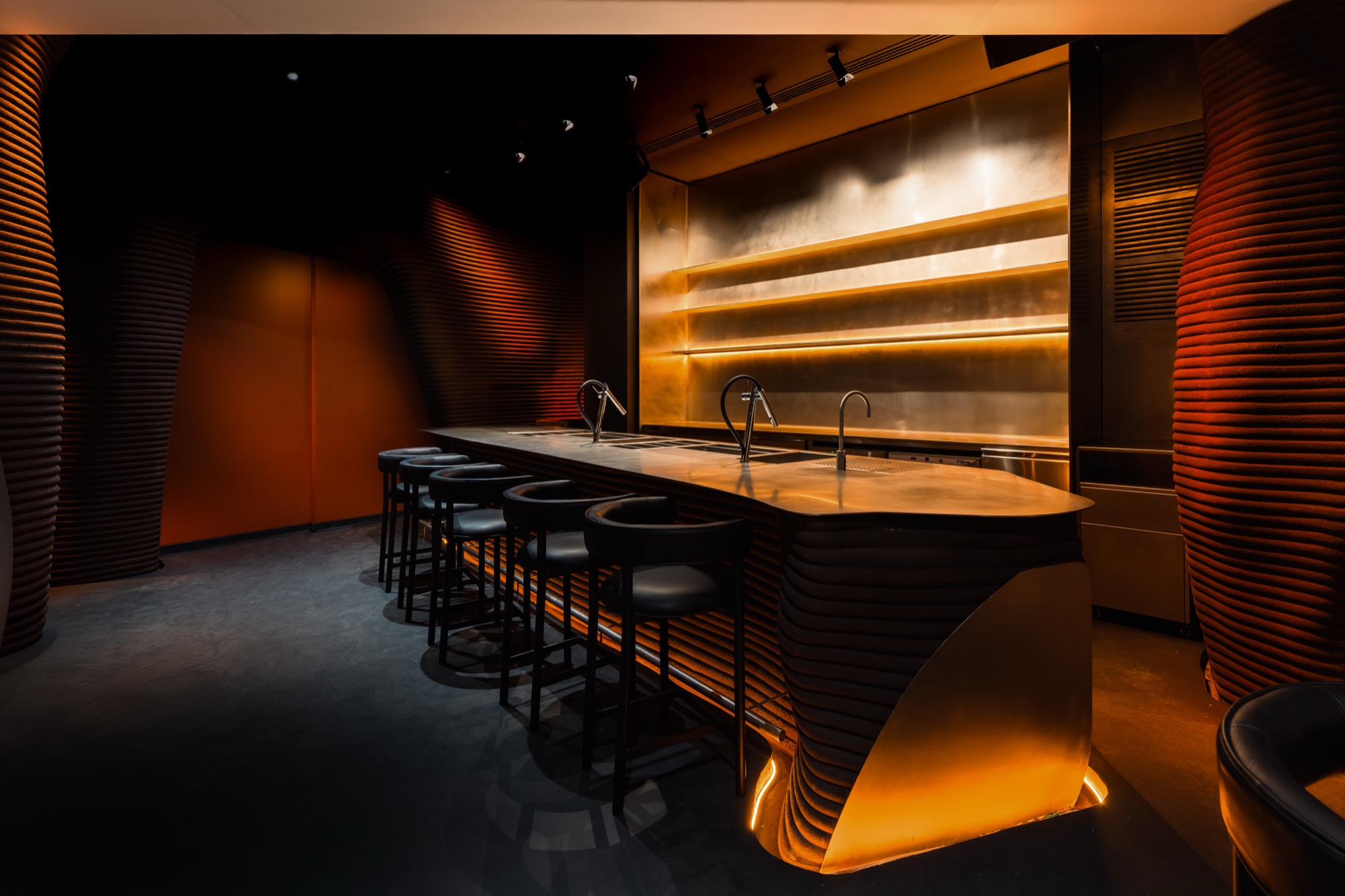 Myata bar counter in service at Cleresdyne, vibration finish catching ambient light in the lounge