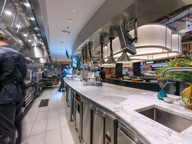 Commercial kitchen installation by Cleresdyne, marble pass and stainless steel cabinetry